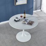The White Round Dining Table is a modern and elegant dining solution designed to bring style, comfort, and functionality to homes, apartments, cafés, restaurants, and office dining spaces. Featuring a clean white finish and a timeless round design, this table creates a welcoming atmosphere where family, friends, and guests can comfortably enjoy meals and conversations. Built from high-quality materials, the table offers excellent strength and durability for everyday use. The smooth tabletop provides a spacious surface for dining, serving meals, placing décor items, or hosting gatherings. Its round shape promotes easy interaction between users while making efficient use of space, making it ideal for both small and large dining areas. The sleek contemporary design complements modern, minimalist, and classic interiors, adding a touch of elegance to any setting. Whether furnishing a home dining room or a commercial space, the White Round Dining Table delivers the perfect combination of beauty, practicality, and long-lasting performance. Key Features Elegant white modern finish Classic round dining table design Strong and durable construction Smooth, easy-to-clean tabletop surface Space-saving design suitable for compact areas Comfortable seating arrangement for family and guests Stable base for reliable support Ideal for homes, apartments, cafés, restaurants, hotels, and office dining areas Complements modern and contemporary décor Built for everyday dining use