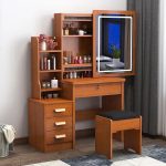 The Brown Dressing Table with Mirror is a stylish and functional furniture piece designed to bring elegance and convenience to your bedroom or dressing area. Featuring a rich brown finish and a large built-in mirror, this dressing table provides the perfect space for your daily grooming, makeup, and skincare routine. Its timeless design complements modern, contemporary, and classic bedroom interiors. Crafted from high-quality engineered wood, the dressing table is built for durability and long-lasting performance. It includes spacious drawers that offer ample storage for cosmetics, jewelry, hair accessories, perfumes, and other personal essentials, helping you keep your space neat and organized. The wide tabletop provides additional room for decorative items and beauty products, while the smooth surface is easy to clean and maintain. Whether you're furnishing a new home or upgrading your bedroom, the Brown Dressing Table with Mirror combines style, practicality, and durability to create a beautiful and organized personal space. Key Features: Elegant brown wood finish Large built-in mirror Spacious storage drawers for cosmetics and accessories Durable engineered wood construction Wide tabletop for beauty essentials and décor Smooth, scratch-resistant, and easy-to-clean surface Strong and stable design for everyday use Suitable for bedrooms, apartments, dressing rooms, and guest rooms Complements modern, classic, and contemporary interiors Easy to assemble and built for long-lasting durability