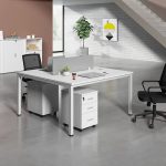 The 2 Way White Office Workstation is a modern and space-saving office furniture solution designed to provide an efficient and comfortable workspace for two users. Featuring a sleek white finish and a contemporary design, this workstation enhances the appearance of any office while promoting collaboration, productivity, and organization. It is ideal for corporate offices, startups, co-working spaces, call centers, educational institutions, and home offices. Constructed from high-quality engineered wood and supported by a sturdy steel frame, the workstation is built for durability and long-term performance. Each user enjoys a spacious work surface for laptops, desktop computers, files, and office accessories, ensuring a clutter-free and productive working environment. The scratch-resistant tabletop is easy to clean, while the strong frame provides excellent stability for everyday use. Designed to maximize office space without compromising comfort, the 2 Way White Office Workstation blends seamlessly with modern, minimalist, and contemporary office interiors. It is an excellent choice for businesses looking to create a professional and organized workspace. Key Features Two-person office workstation design Elegant white modern finish Spacious individual workstations Durable engineered wood tabletop Heavy-duty steel frame for enhanced stability Scratch-resistant and easy-to-clean surface Space-saving design for efficient office layouts Suitable for offices, co-working spaces, call centers, schools, and home offices Modern appearance that complements contemporary interiors Easy to assemble and built for long-lasting daily use