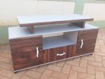 1.8 meters wooden tv stand, 1.8 meter wooden tv stand, 1.8m wooden tv stand, 180cm wooden tv stand, 1.8 meters tv cabinet, 1.8 meter tv cabinet, 1.8m tv cabinet, 180cm tv cabinet, wooden tv stand, wooden tv cabinet, wooden tv console, wooden tv unit, tv stand with storage, wooden tv stand with storage, tv cabinet with storage, wooden entertainment unit, wooden media console, wooden tv console table, living room tv stand, living room tv cabinet, modern wooden tv stand, modern tv cabinet, contemporary wooden tv stand, stylish wooden tv stand, elegant wooden tv stand, minimalist wooden tv stand, solid wood tv stand, wooden media cabinet, wooden entertainment cabinet, wooden television stand, television cabinet wooden, tv furniture kenya, tv stand kenya, wooden tv stand kenya, 1.8m tv stand kenya, 1.8 meter tv stand kenya, 1.8 meters tv stand kenya, 180cm tv stand kenya, The 1.8 Meters Wooden TV Stand provides a spacious and organized base for your television and entertainment equipment. Its 1.8-meter width offers enough room for a large TV, decoder, sound system, gaming console, remote controls, and decorative accessories. The wooden design adds a warm and elegant touch to living rooms and entertainment spaces. 1.8 Meters Wooden TV Stand, 1.8 Meters Wooden TV Stand Kenya, 1.8 Meters Wooden TV Stand Nairobi, 1.8 Meters Wooden TV Stand Kisumu, 1.8 Meters Wooden TV Stand Kisii, 1.8 Meters Wooden TV Stand Mombasa, 1.8 Meters Wooden TV Stand Nakuru, 1.8 Meters Wooden TV Stand Eldoret, 1.8 Meters Wooden TV Stand Thika, 1.8 Meters Wooden TV Stand Machakos, 1.8 Meters Wooden TV Stand Nyeri, 1.8 Meters Wooden TV Stand Meru, 1.8 Meters Wooden TV Stand Kakamega, 1.8 Meters Wooden TV Stand Kitale, 1.8 Meters Wooden TV Stand Kericho, 1.8 Meters Wooden TV Stand Bungoma, 1.8 Meters Wooden TV Stand Malindi, 1.8 Meters Wooden TV Stand Naivasha, 1.8 Meters Wooden TV Stand Nanyuki, 1.8 Meters Wooden TV Stand Migori, 1.8 Meters Wooden TV Stand Homa Bay, 1.8 Meters Wooden TV Stand Siaya, 1.8 Meters Wooden TV Stand Busia, 1.8 meters wooden tv stand delivery kenya, 1.8 meters wooden tv stand delivery nairobi, 1.8 meters wooden tv stand delivery kisumu, 1.8 meters wooden tv stand delivery mombasa, 1.8 meters wooden tv stand delivery kisii, 1.8 meters wooden tv stand delivery nakuru, 1.8 meters wooden tv stand delivery eldoret, 1.8 meters wooden tv stand delivery thika, 1.8 meters wooden tv stand delivery kiambu, 1.8 meters wooden tv stand delivery machakos, 1.8 meters wooden tv stand delivery nyeri, 1.8 meters wooden tv stand delivery kakamega, 1.8 meters wooden tv stand delivery homa bay, 1.8 meters wooden tv stand delivery migori, 1.8 meters wooden tv stand delivery kericho, 1.8 meters wooden tv stand delivery bungoma, 1.8 meters wooden tv stand delivery siaya, 1.8 meters wooden tv stand delivery vihiga, 1.8 meters wooden tv stand delivery kitale, 1.8 meters wooden tv stand delivery naivasha, 1.8 meters wooden tv stand delivery meru, 1.8 meters wooden tv stand delivery embu Ideal for living rooms, bedrooms, lounges, apartments, offices, hotels, and entertainment areas, the 1.8 Meters Wooden TV Stand helps create a neat and organized media space. Its spacious design makes it suitable for larger television setups while providing convenient storage and display space for everyday essentials. Combining functionality with a classic wooden appearance, it is a practical addition to modern and traditional interiors. The 1.8 Meters Wooden TV Stand is a practical entertainment furniture piece designed to provide a stable and organized space for your television and media equipment. Its 1.8-meter width offers a generous surface for placing a TV, while the wooden design adds a warm and classic appearance to the living room. It is suitable for homes, apartments, lounges, bedrooms, offices, and entertainment areas The 1.8 Meters Wooden TV Stand is a practical and stylish addition to modern living rooms. With a 1.8-meter width, it provides a spacious surface for placing a television and creating an organized entertainment area. Its wooden design adds a warm, natural appearance that can complement different living room furniture and interior styles. The 1.8 Meters Wooden TV Stand is a stylish and practical entertainment unit designed to support your television while providing space for media accessories and household essentials. Its 1.8-meter length offers a generous surface for different TV sizes, while the wooden construction adds a warm and classic touch to the living room.
